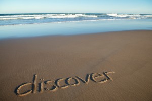 word discover written on beach with sand