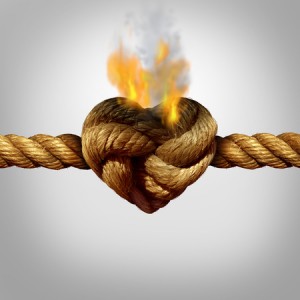 44492771 - divorce and separation concept as a rope with a burning knot shaped as a love heart as a relationship problem symbol or infidelity crisis icon between a couple.